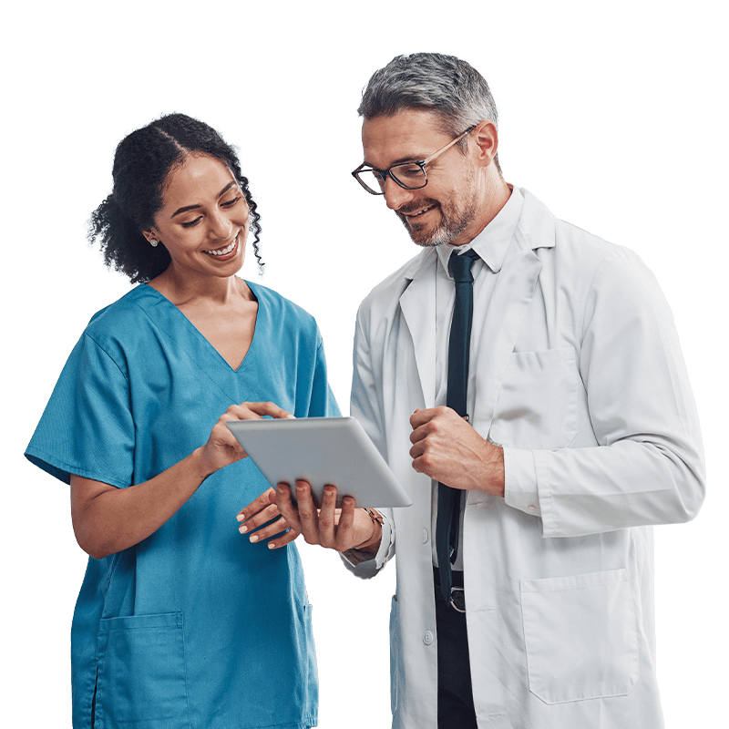 A male doctor in a white coat holding a tablet computer, looking at the screen with a focused expression.