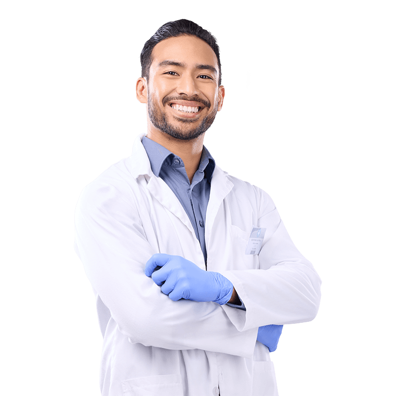 A male doctor in a white coat holding a tablet computer, looking at the screen with a focused expression.