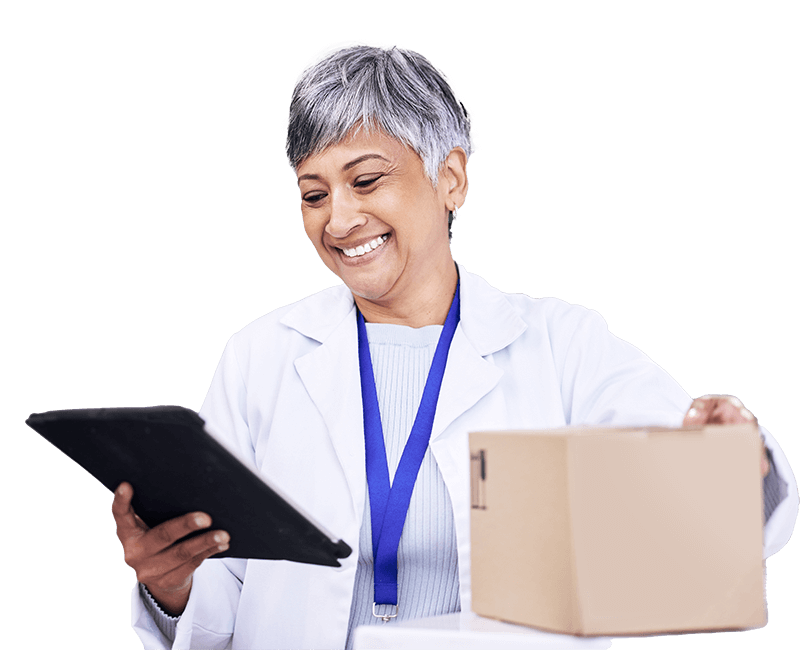 A male doctor in a white coat holding a tablet computer, looking at the screen with a focused expression.