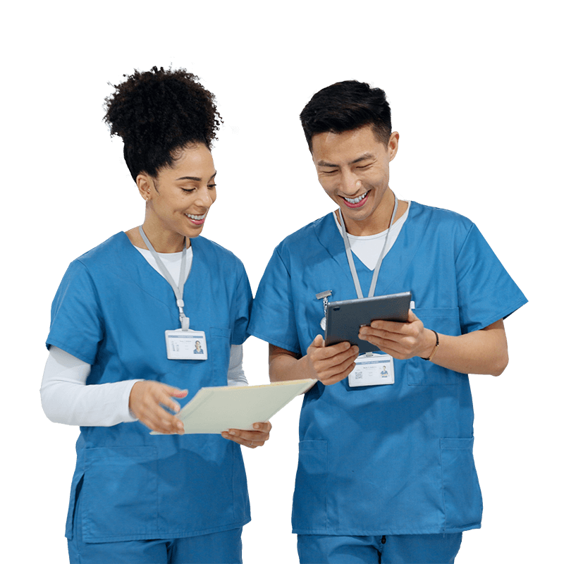 A male doctor in a white coat holding a tablet computer, looking at the screen with a focused expression.